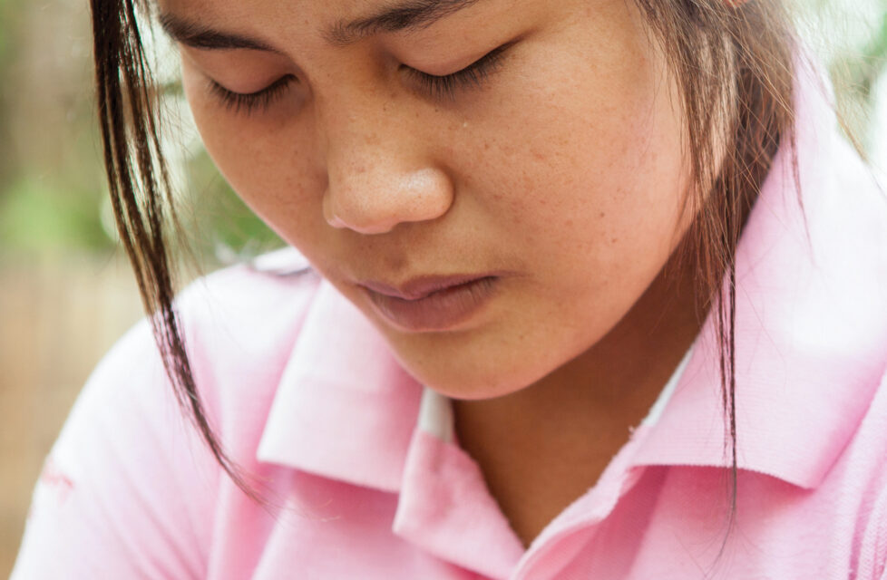 An up close picture of a woman praying