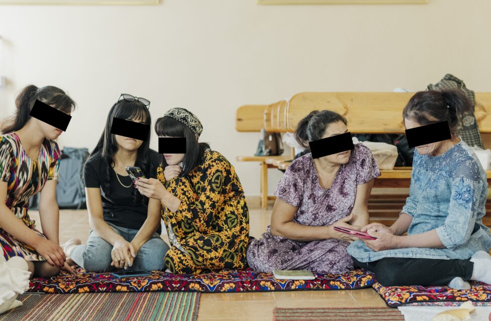 Praying women with black blocks around eyes to protect their identities. President's Letter Story.